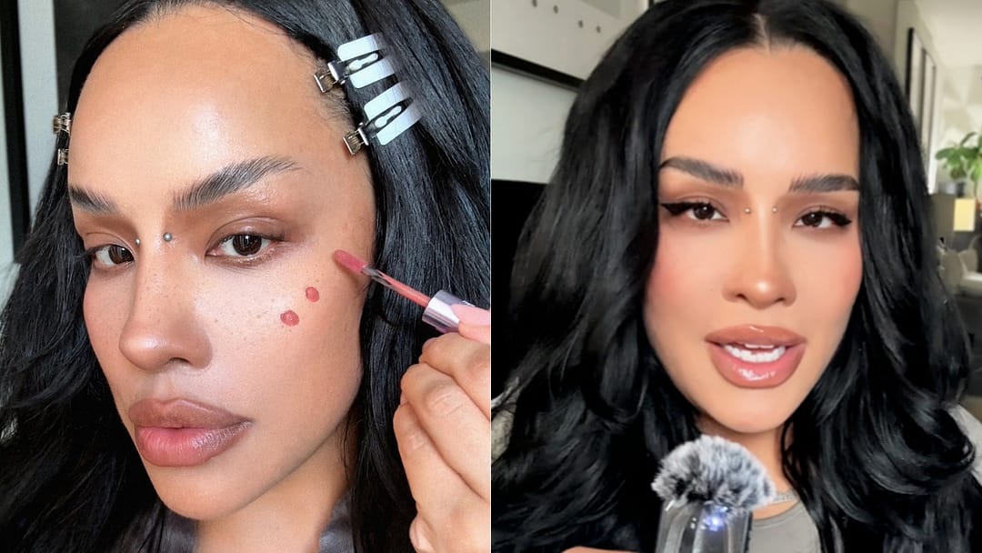 Side-by-side beauty images featuring a woman with long black hair and a silver bridge piercing. On the left, she applies rosy liquid blush to her cheek with a doe-foot applicator while her hair is clipped back for makeup application. On the right, she showcases the finished look with soft pink cheeks, winged eyeliner, glossy lips, and voluminous waves, speaking into a small microphone.
